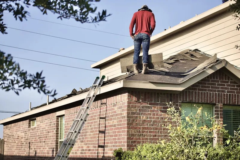 Professional roofer working on a residential roof in Brooks Edge